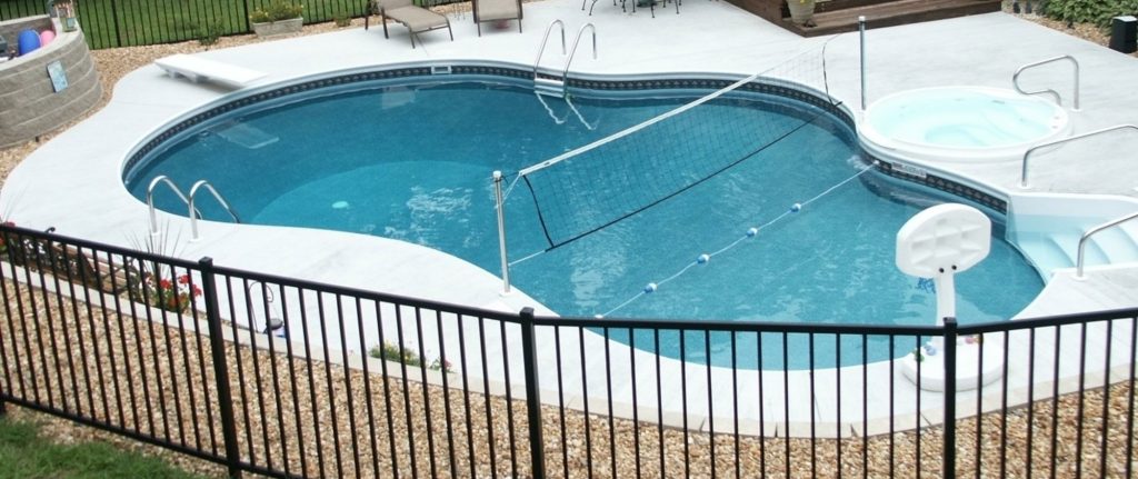 Inground pool with attached spa and aluminum pool fence in Virginia