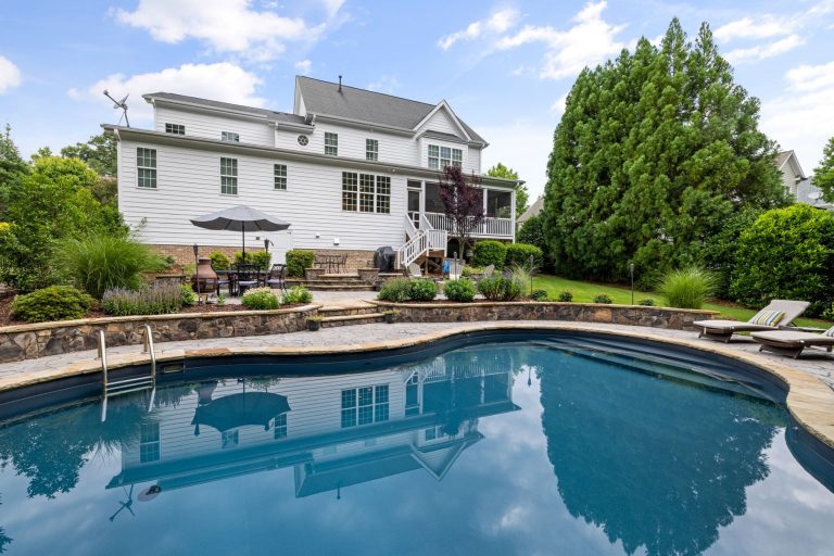 Inground pool installation in Winchester VA with landscaped patio and lawn