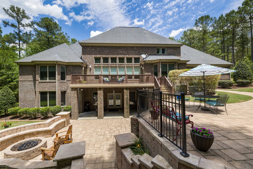 Outdoor living space with patio fire pit and retaining wall in Virginia